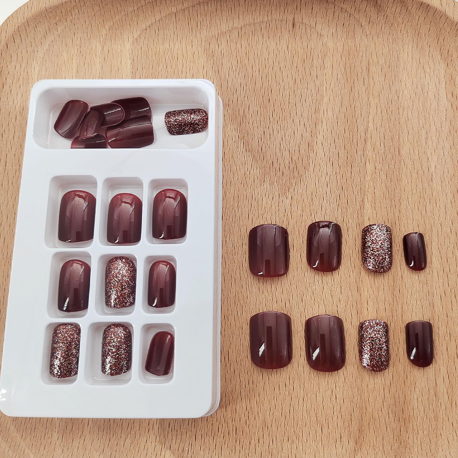 Close-up of Xenophoer burgundy press-on nails showing flexible base for fit