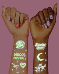xo Fetti disco glow groovy text tattoo adds retro party flair.