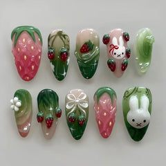 XUNCUNFAN almond medium press-on nails with French tip and 3D strawberry design for stylish, reusable wear.