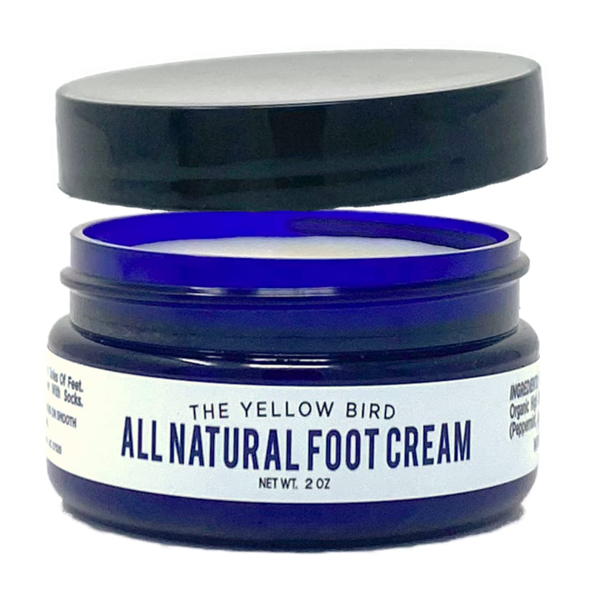 The Yellow Bird foot cream with tea tree oil in a jar delivers hydrating care.