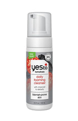 Yes To Tomatoes detoxifying cleanser bottle shows charcoal formula for deep pore cleansing in urban environments.
