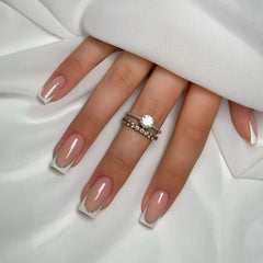 YIYILEIC French medium press-on nails in nude gloss with white border for elegant everyday wear.