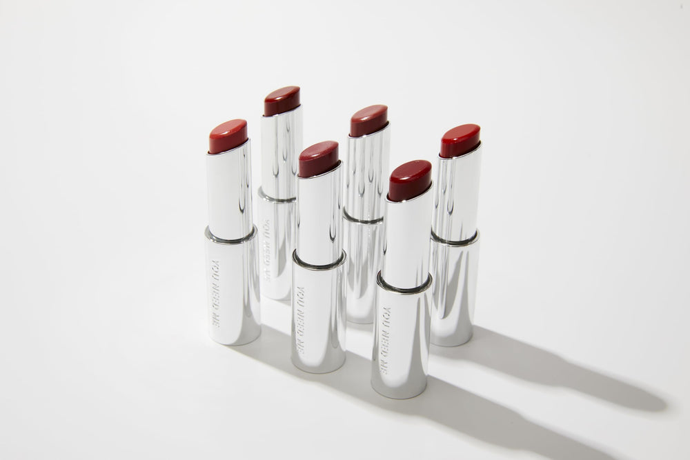 Applying a small amount for buildable color with YNM Balm