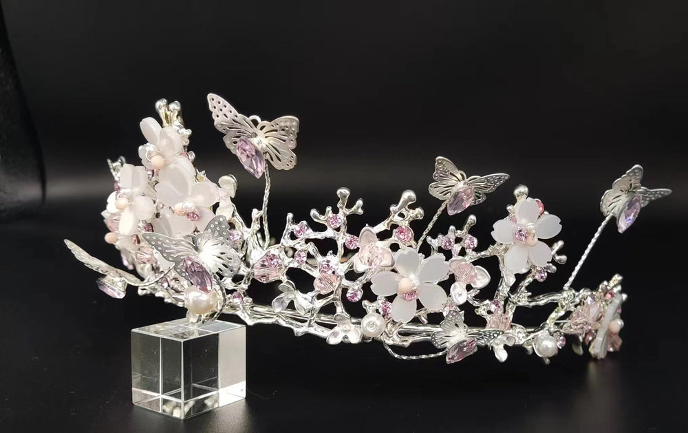 Yunyuebridal silver pink crown closeup highlighting butterfly motif.