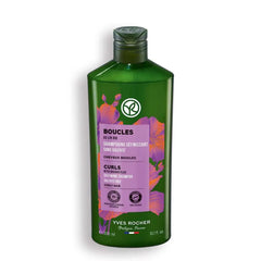 Yves Rocher Curls Shampoo bottle pouring, showcasing organic flax extract for nourished curls.