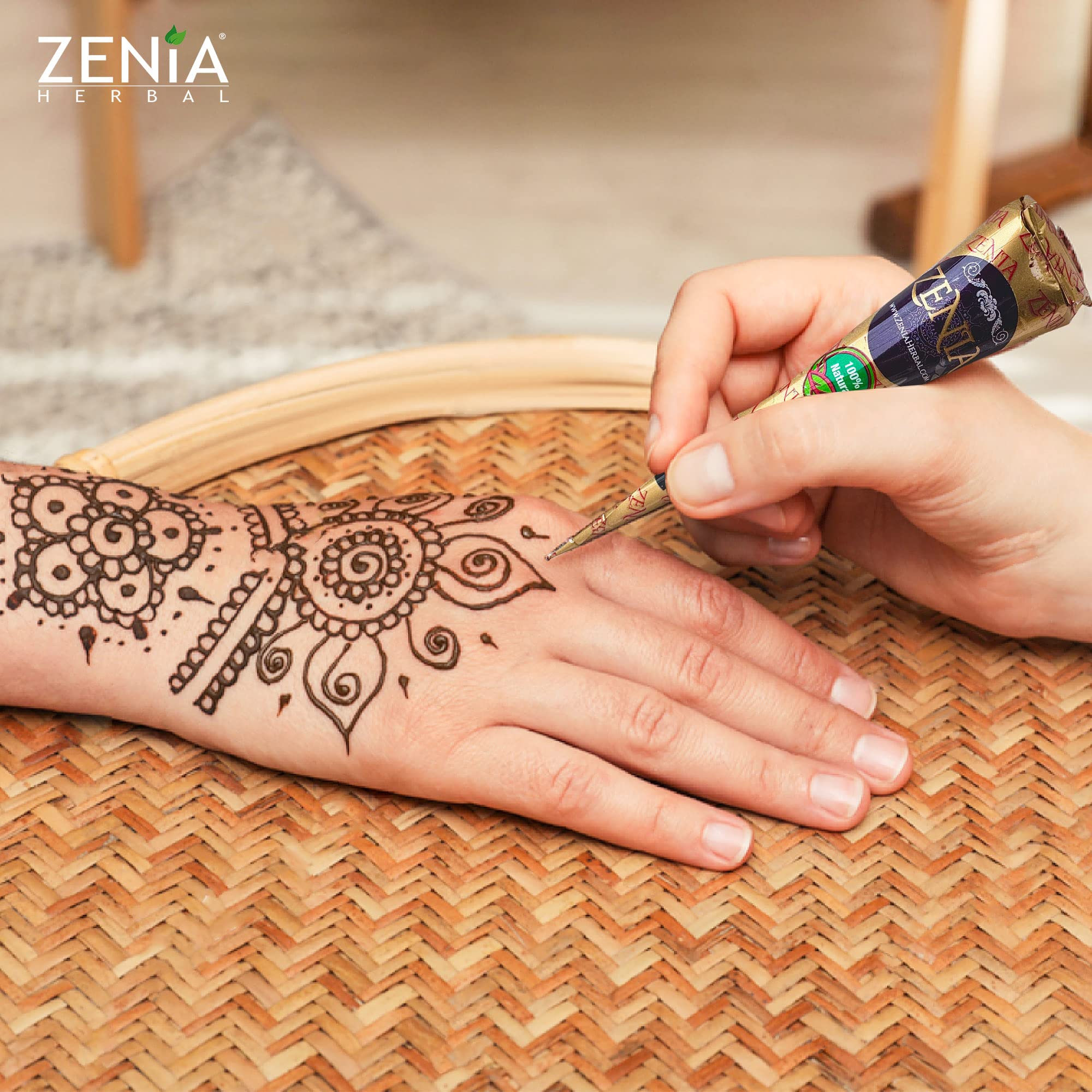 Zenia user applying a temporary tattoo with the paste cone