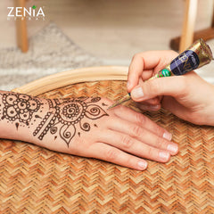 Zenia user applying a temporary tattoo with the paste cone