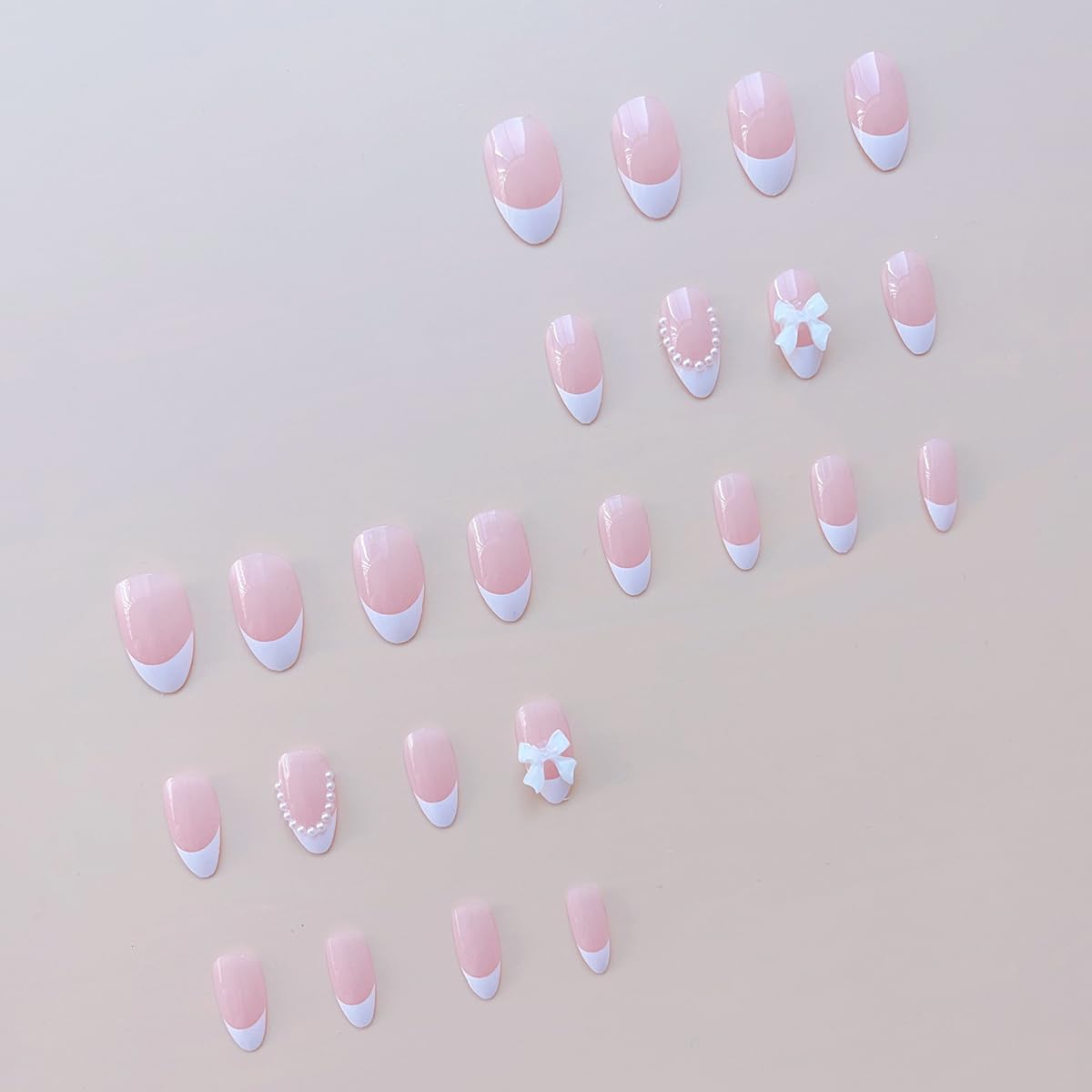 ZRETHFB pearl bow design nails with short almond shape for chic everyday looks.