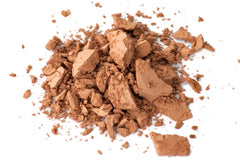 Zuzu Luxe D-24 foundation being applied with a soft brush for seamless coverage.